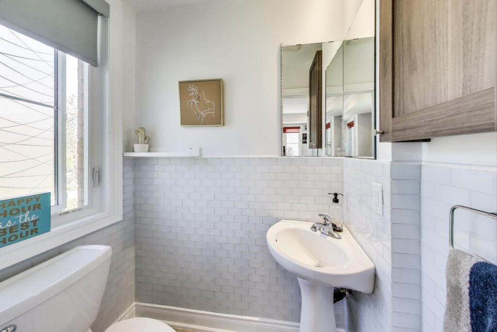 Main floor powder room at 380 Hopewell Ave #231 with heated floors, modern vanity, and elegant finishes—perfect for guest comfort.