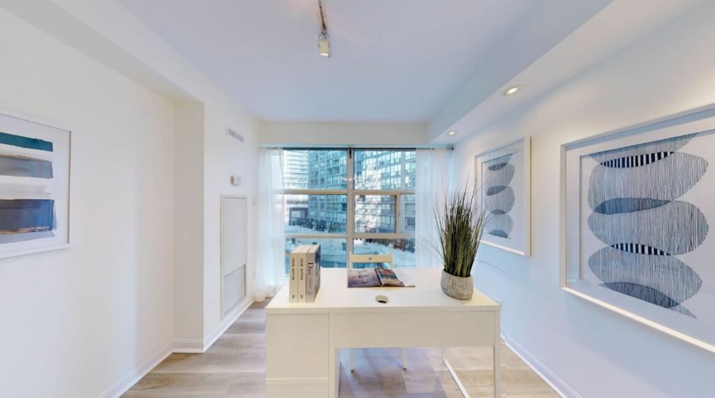 Den at 11 St Joseph St #402 with window overlooking a quiet courtyard and south-facing street exposure, ideal for a serene home office or guest room.