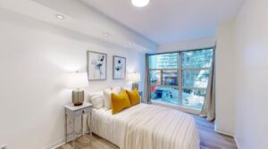 Primary bedroom at 11 St Joseph St #402 featuring neutral finishes, ample space for a full bedroom set, and a large walk-in closet.