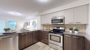 View from the kitchen at 11 St Joseph St #402 overlooking the dining and living area, highlighting the open-concept layout and spacious design.