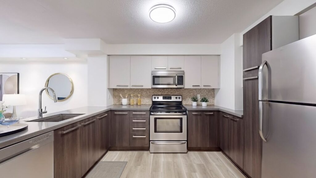 Straight-on view of the kitchen at 11 St Joseph St #402 from the entryway, showcasing full-size appliances, ample cabinetry, and a large central island.