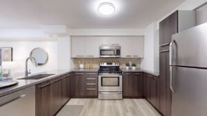 Straight-on view of the kitchen at 11 St Joseph St #402 from the entryway, showcasing full-size appliances, ample cabinetry, and a large central island.