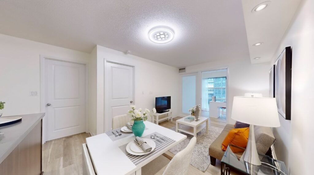 Dining area at 11 St Joseph St #402 with a clear view toward the primary bedroom entrance, highlighting the functional layout and natural flow of the space.