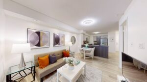 Open-concept living and dining area at 11 St Joseph St #402 with view into spacious kitchen featuring island seating and ample cabinetry.