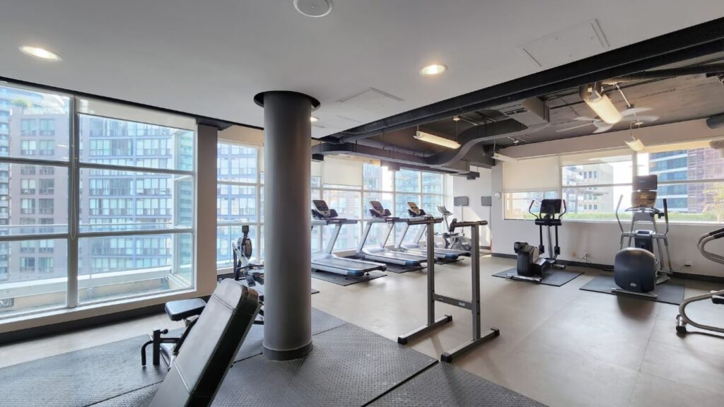 Weight training area in the fitness centre at Eleven Residences, 11 St Joseph St, equipped with free weights, benches, and strength machines for resident use.