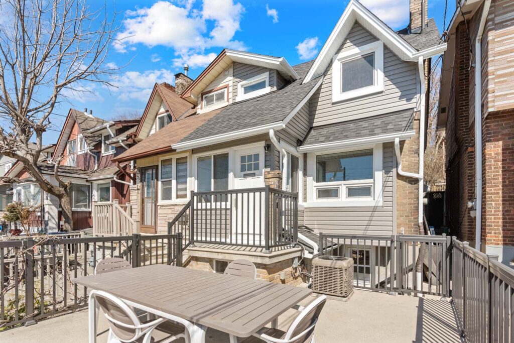 Exterior view of 1370 Davenport Rd, a raised three-bedroom Toronto home with skyline views, front patio, and CN Tower sightlines.