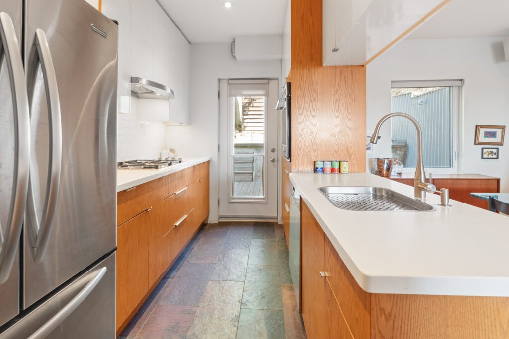 Modern kitchen at 1370 Davenport Rd featuring stainless steel appliances, gas cooktop, built-in oven, sleek cabinetry, and open-concept design.