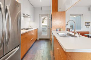 Modern kitchen at 1370 Davenport Rd featuring stainless steel appliances, gas cooktop, built-in oven, sleek cabinetry, and open-concept design.