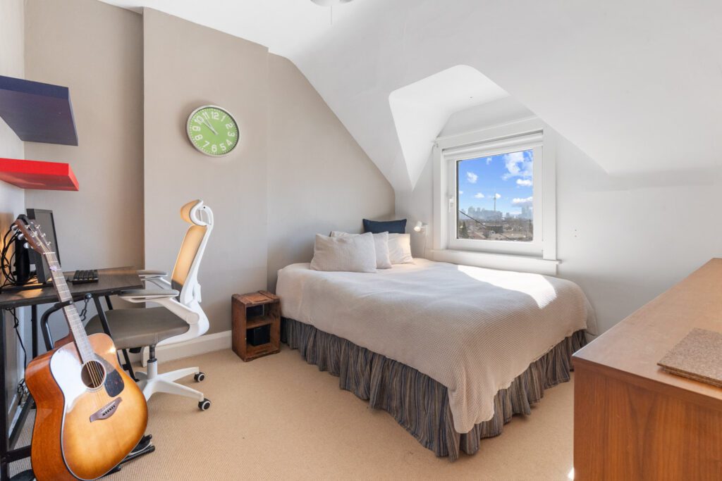 Second bedroom at 1370 Davenport Rd with CN Tower views, large window, natural light, and cedar-lined closet.