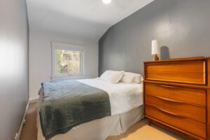 Primary bedroom at 1370 Davenport Rd with serene backyard views, spacious layout, and double cedar-lined closet.