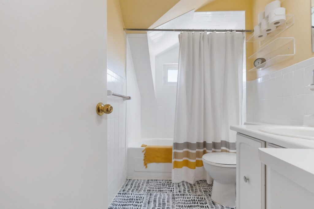 Bathroom at 1370 Davenport Rd featuring window inside the shower with rare CN Tower view, modern tile, and glass shower enclosure.