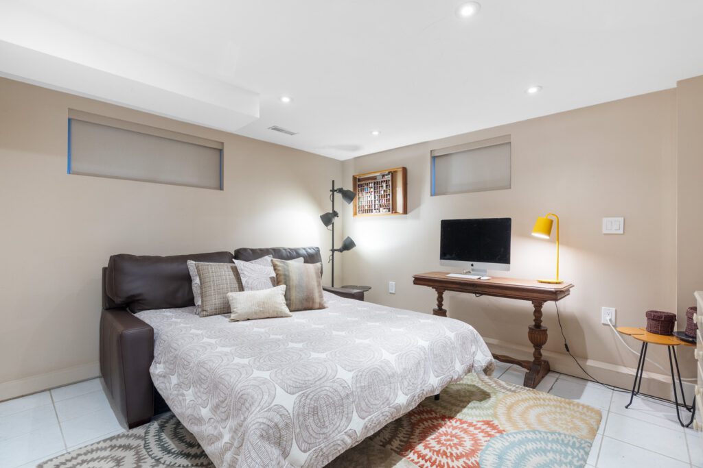 Finished basement at 1370 Davenport Rd staged as a bedroom with cozy layout, soft lighting, and versatile space for guests or home office.