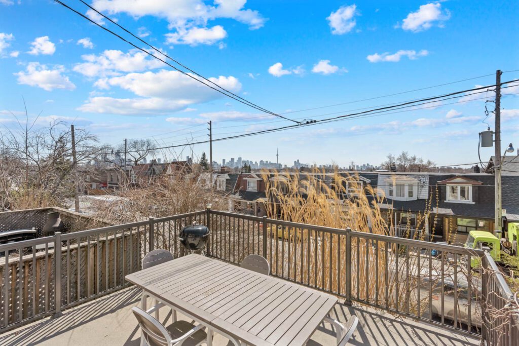 Front porch at 1370 Davenport Rd with CN Tower view, elevated above street level for privacy, perfect for morning coffee or evening sunsets.