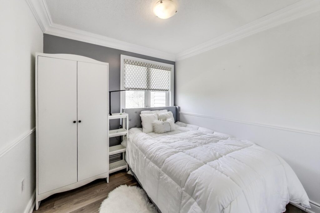 Second bedroom at 380 Hopewell Ave #231, ideal as a nursery, home office, or guest room, featuring a bright window and flexible layout.