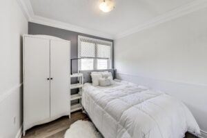 Second bedroom at 380 Hopewell Ave #231, ideal as a nursery, home office, or guest room, featuring a bright window and flexible layout.