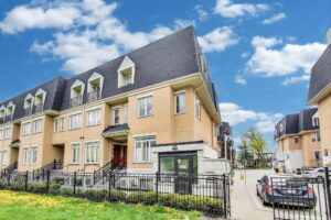 Exterior view of the townhouse complex at 380 Hopewell Ave featuring brick façades, landscaped walkways, and a quiet, family-friendly setting in Toronto.
