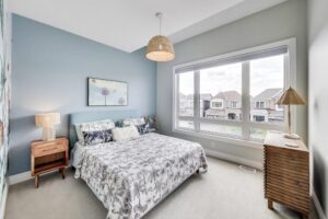 Bright second bedroom with big window and blue feature wall—59 Maskells Cres, Whitby.