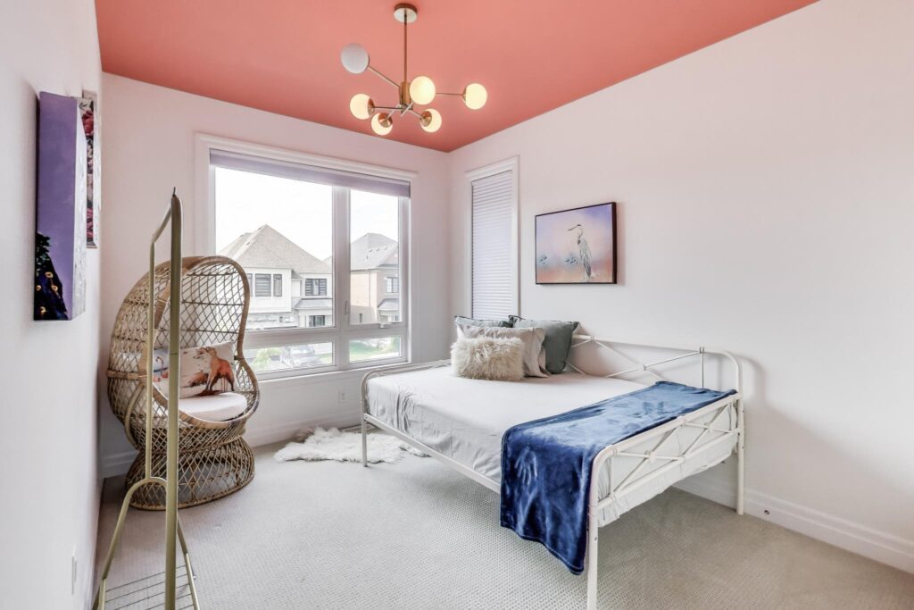 Bedroom 3 at 59 Maskells Cres with modern pendant, daybed and wide window to the street.