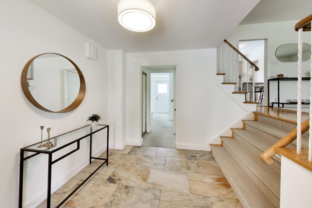 Front foyer at 22 Crossbow Crescent showing the split-level staircase and entry layout.