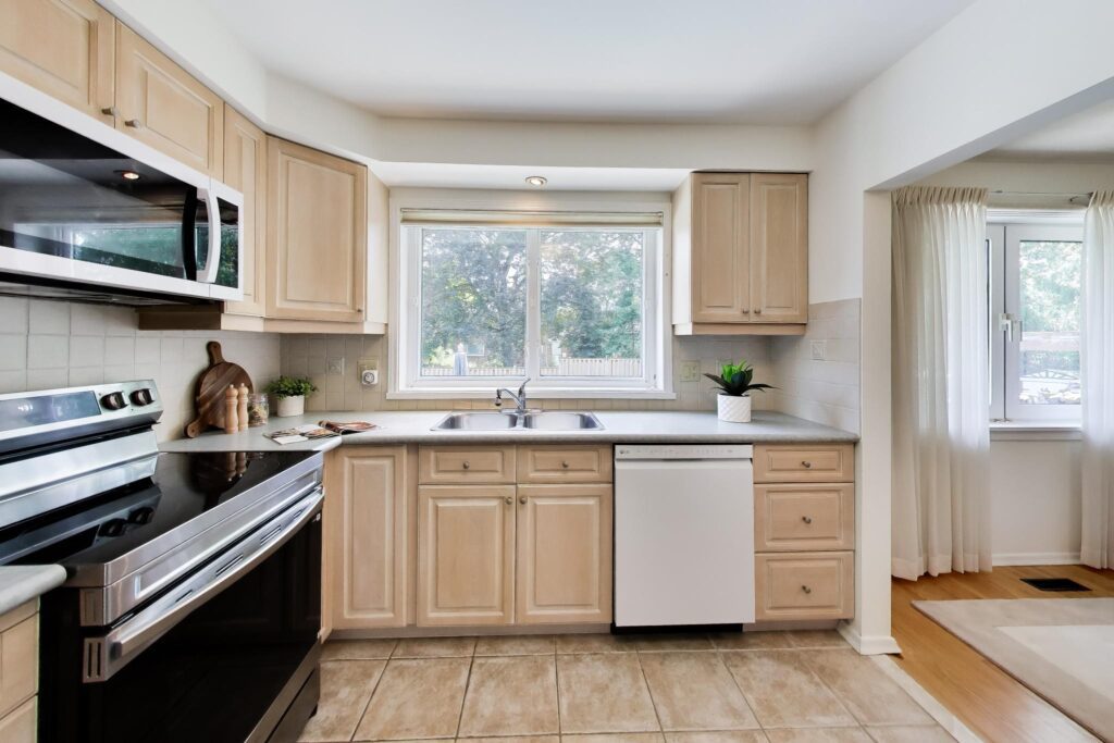 Updated eat-in kitchen with stainless steel appliances and backyard views at 22 Crossbow Crescent in Pleasant View, Toronto