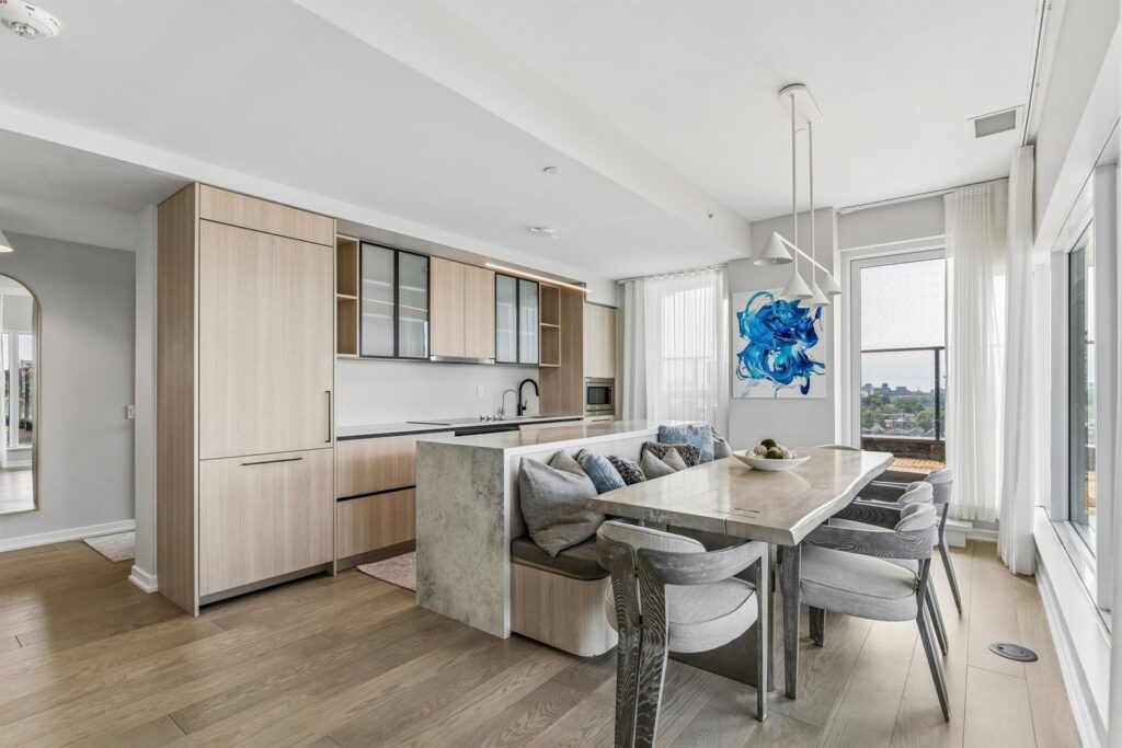 pen-concept kitchen and dining area at 10 Graphophone Grove #702, Toronto