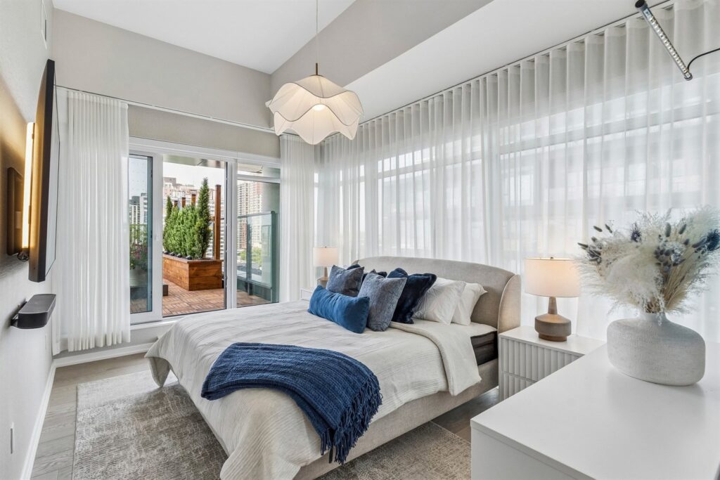 Primary bedroom with terrace access at 10 Graphophone Grove #702, Toronto